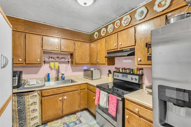 a kitchen with a sink cabinets and appliances