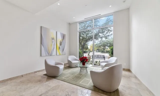 a view of a patio with couches table and chairs and potted plants