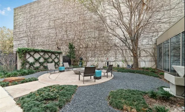 a view of a patio with table and chairs and potted plants