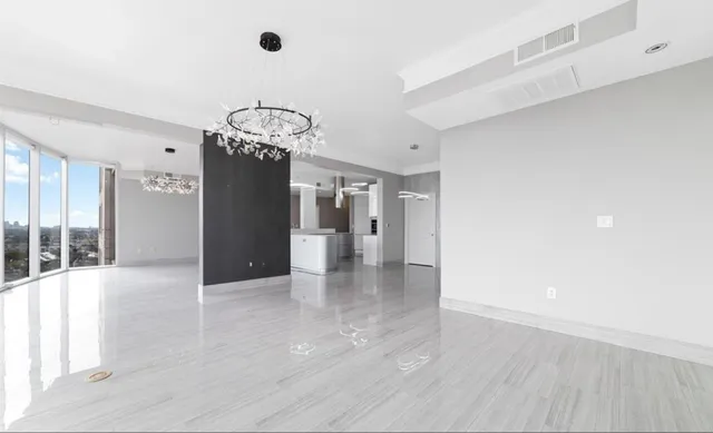 a view of a room with gym equipment and windows