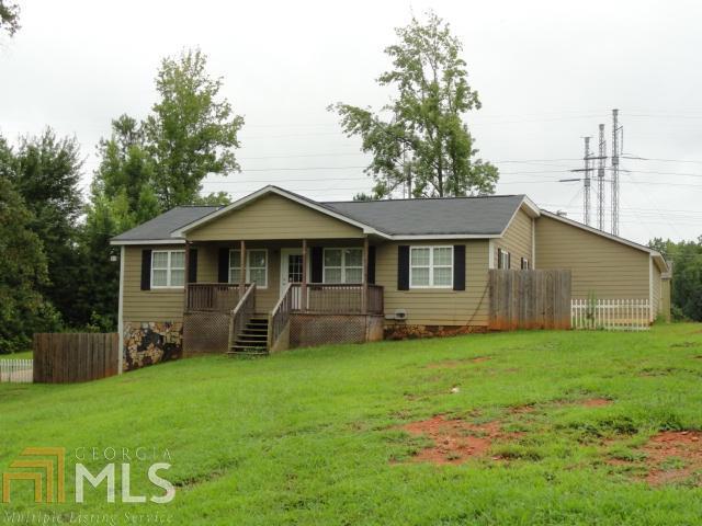 7190 Johnson Road Palmetto, GA 30268 - Photo 1 of 1 a front view of a house with a yard and trees