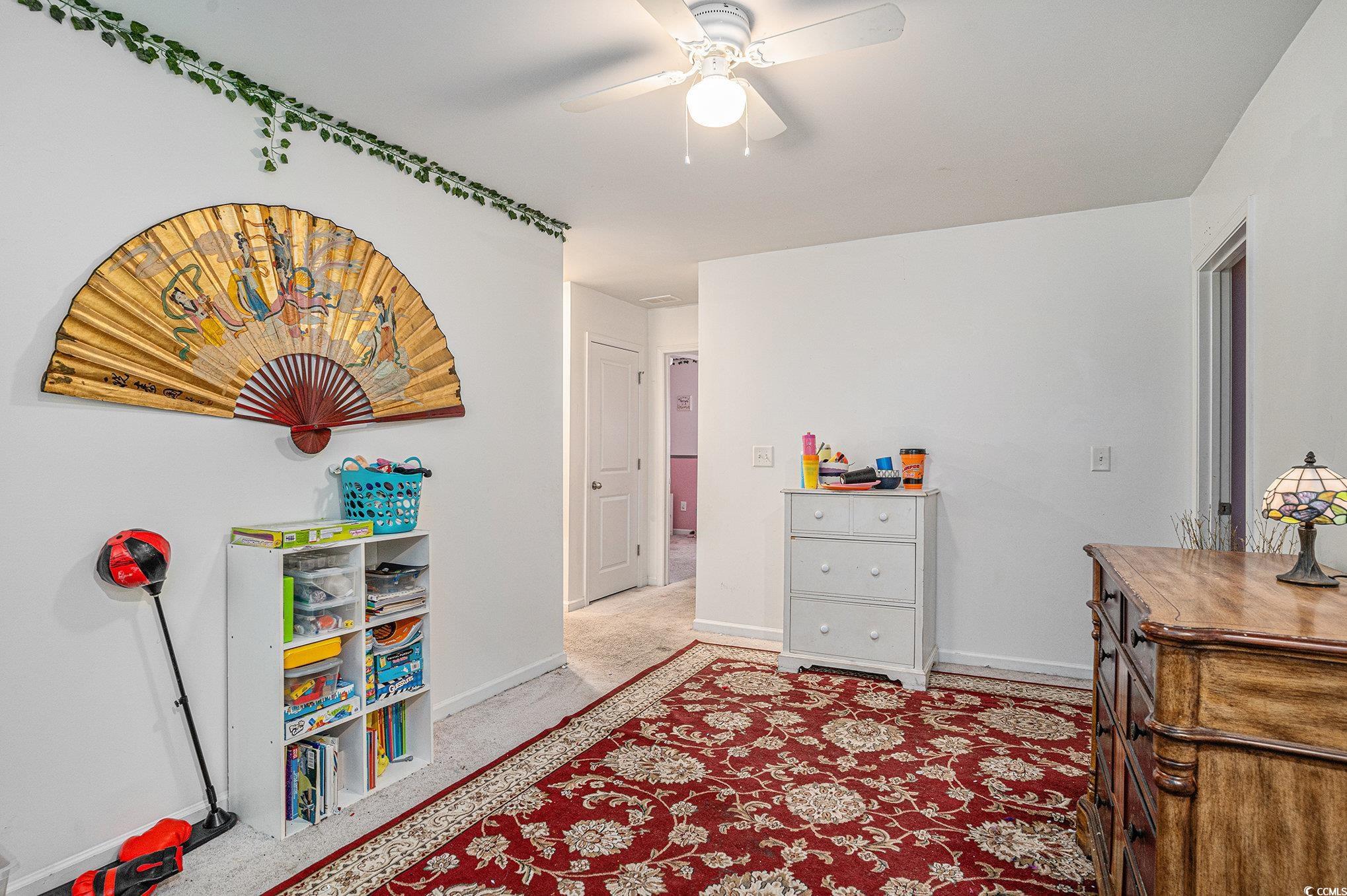 2059 Borgata Loop Longs, SC 29568 - Photo 19 of 34 Bedroom featuring baseboards, ceiling fan, and lig
