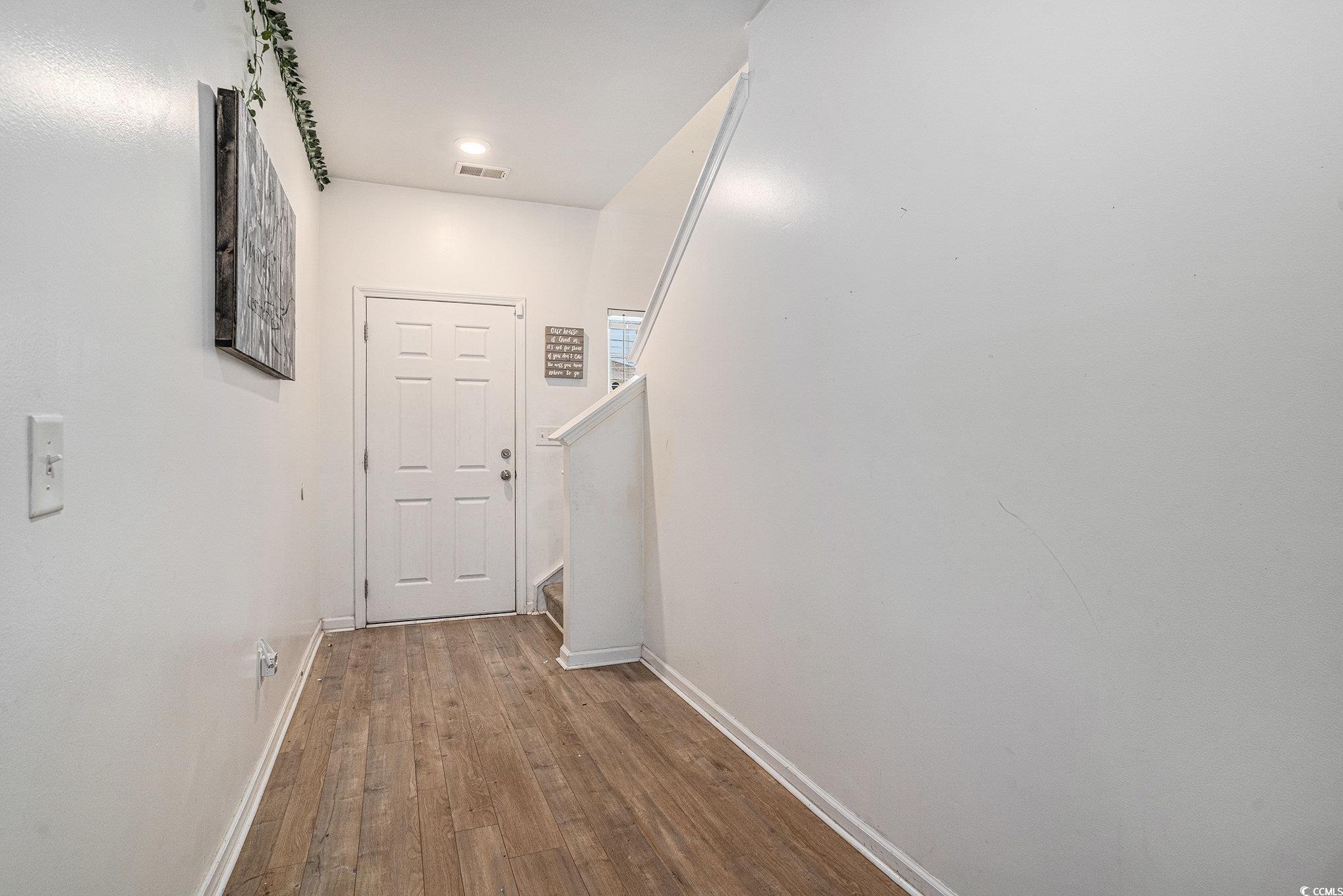 2059 Borgata Loop Longs, SC 29568 - Photo 20 of 34 Doorway to outside featuring baseboards, wood fini
