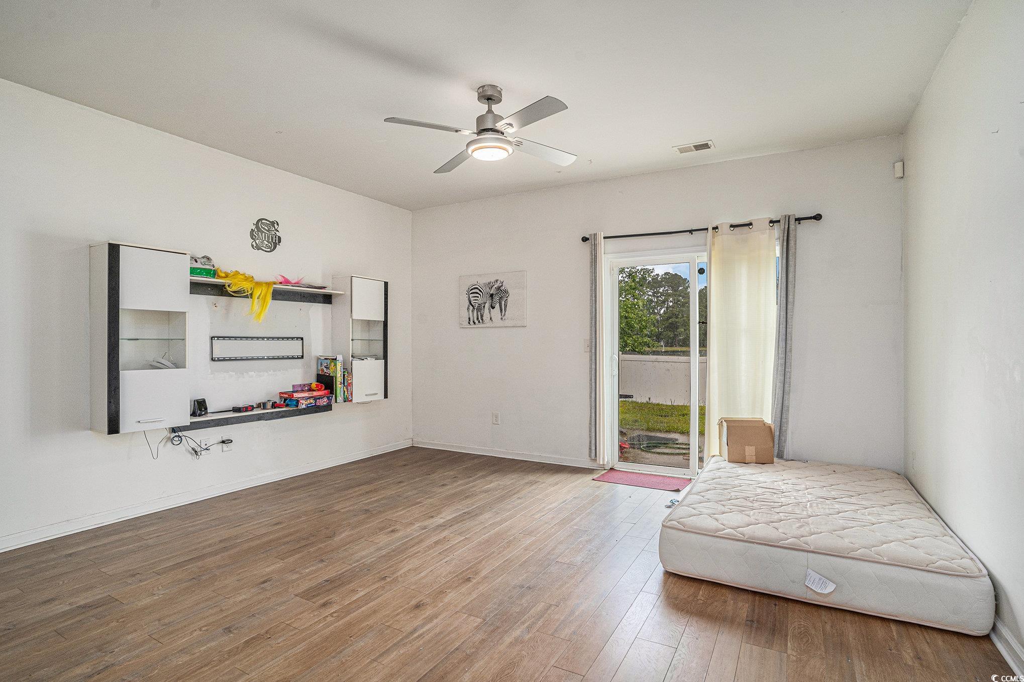 2059 Borgata Loop Longs, SC 29568 - Photo 8 of 34 Sitting room with a ceiling fan, wood finished flo