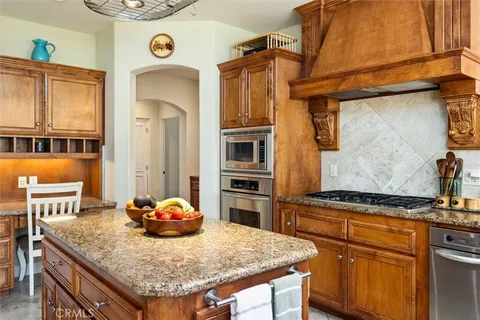 a kitchen with cabinets and wooden floor