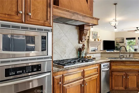 a kitchen with stainless steel appliances granite countertop a stove and a microwave