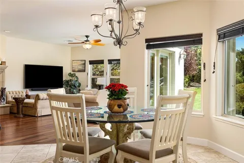 a view of a dining room with furniture wooden floor and chandelier