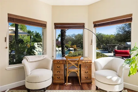 a living room with furniture a rug and a large window
