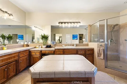 a kitchen with kitchen island a sink stainless steel appliances and cabinets