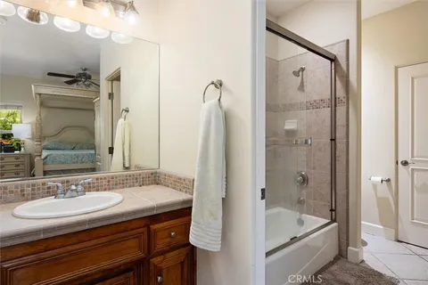 a bathroom with a bath tub sink mirror and shower