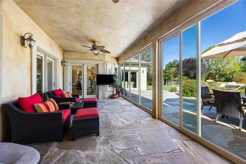 a living room with furniture fireplace and a large window