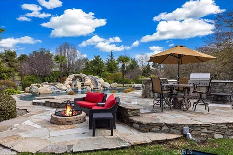 a view of a backyard with sitting area and fire pit