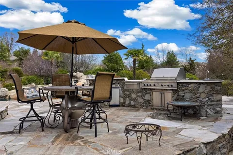 a view of a tables and chairs under an umbrella