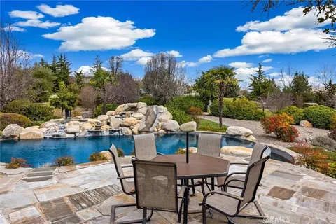 a view of a patio with dining table and chairs with wooden floor