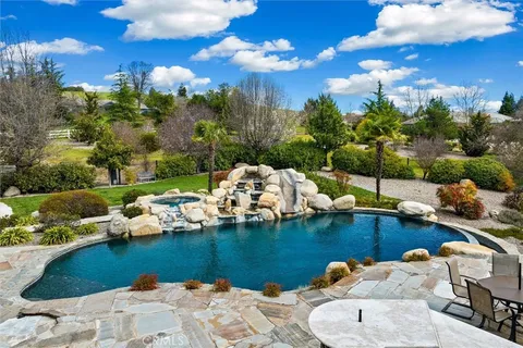 a view of a lake with lawn chairs
