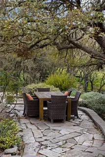 a backyard of a house with table and chairs