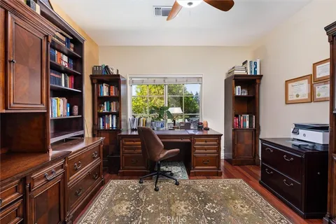 a view of a workspace with furniture and cabinet