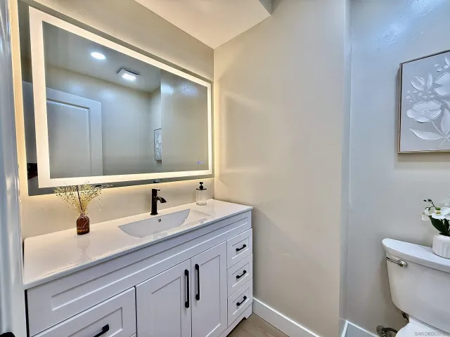 a spacious bathroom with a double vanity sink and mirror