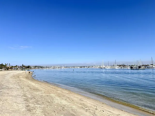 a large room with mirror and view of living room