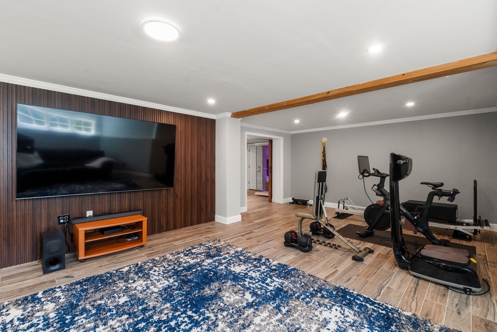 24 Russett Hill Road Sherborn, MA 01770 - Photo 30 of 39 a room with gym equipment and a flat screen tv