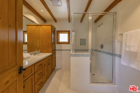 a view of a balcony with chairs and wooden floor