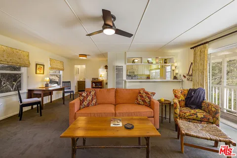a view of a lush green field with a view of mountains in the background