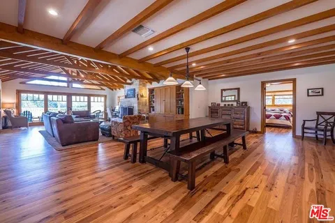 a view of a dining room with furniture wooden floor and chandelier