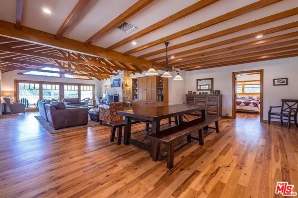 a kitchen with a table chairs stove and cabinets