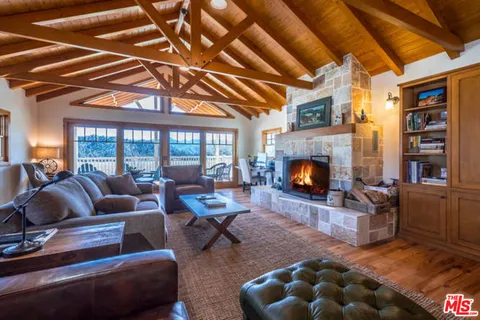 a kitchen with a stove a sink dishwasher and a refrigerator with wooden floor