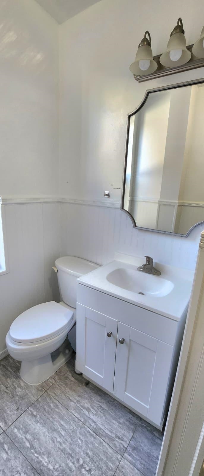 761 Avenue A, Unit 5 Bayonne, NJ 07002 - Photo 3 of 12 a white toilet sitting next to a bathroom sink