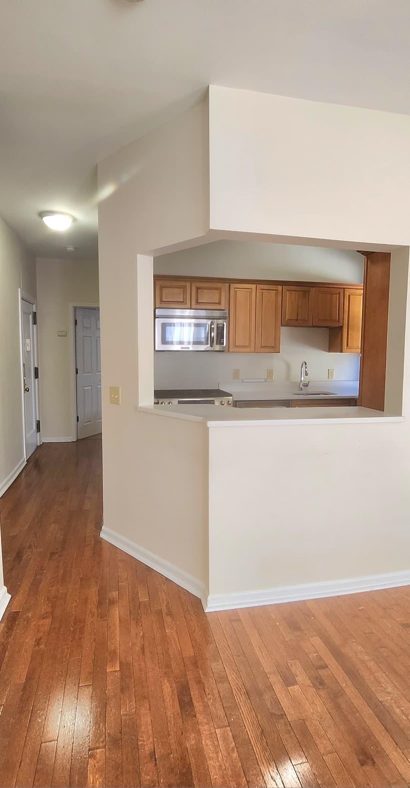 761 Avenue A, Unit 5 Bayonne, NJ 07002 - Photo 10 of 12 a view of a kitchen with a sink and wooden floor