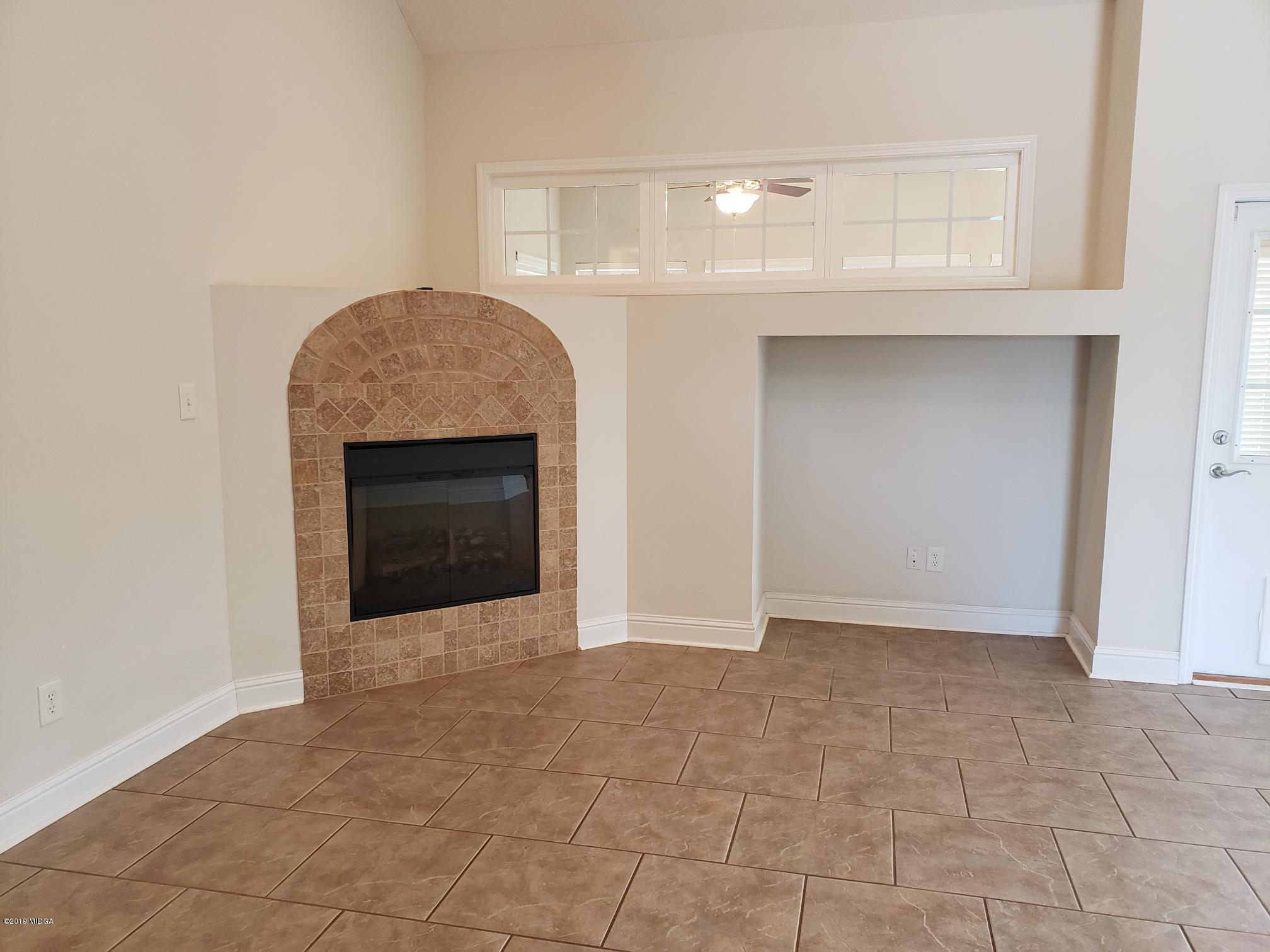 100 Timber Ridge Circle Byron, GA 31008 - Photo 4 of 35 a view of an empty room with a fireplace and a window