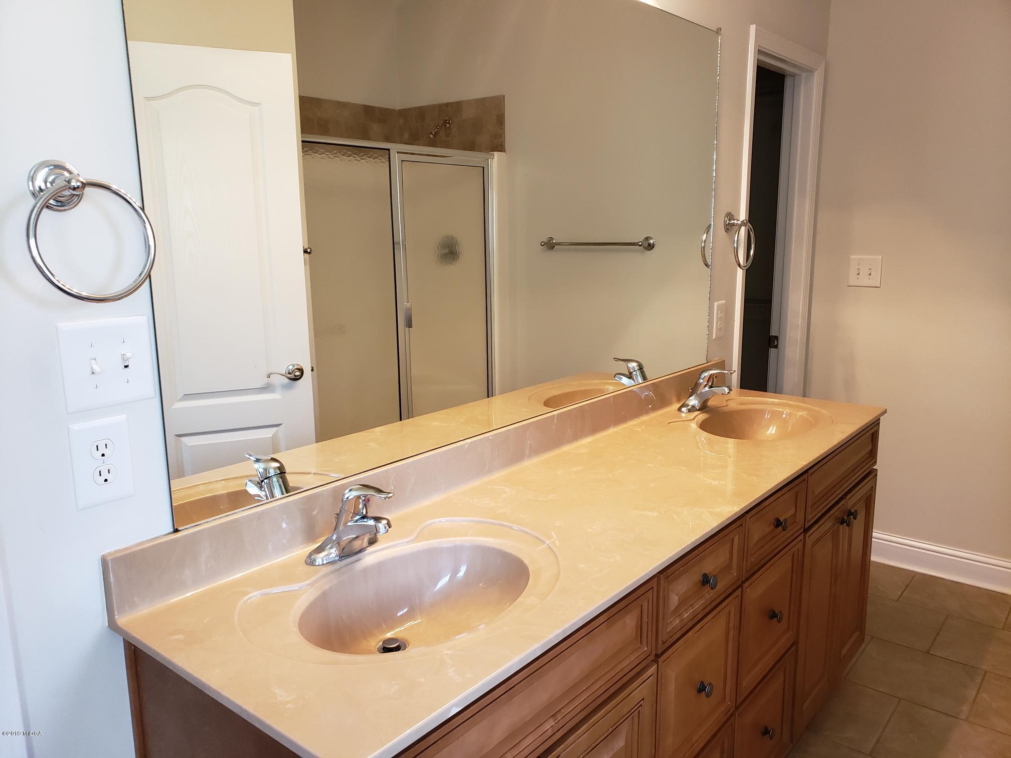 100 Timber Ridge Circle Byron, GA 31008 - Photo 9 of 35 a bathroom with a sink and a mirror