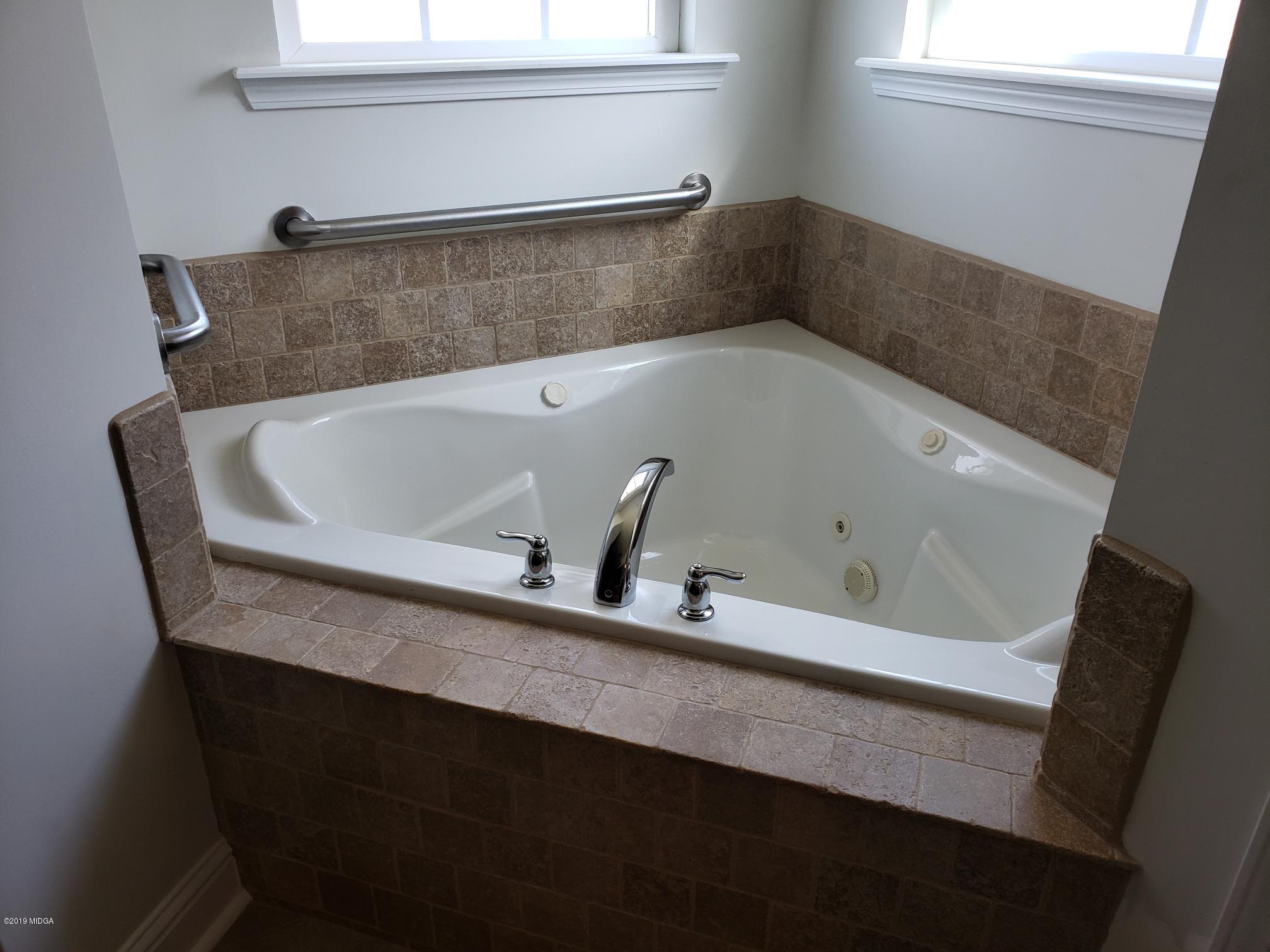 100 Timber Ridge Circle Byron, GA 31008 - Photo 10 of 35 a bath tub sitting in a bathroom next to a window