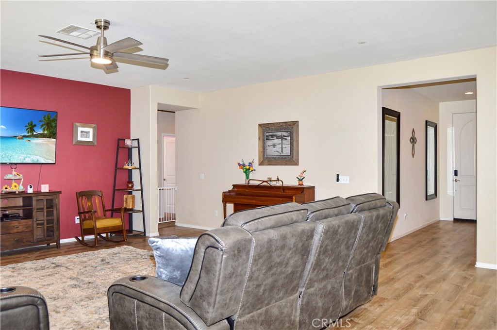 166 Fox Lane Calimesa, CA 92320 - Photo 10 of 76 Spacious Great-Room-Style Living Room with Fabulous Flooring, Ceiling Fan, and Backyard Views (TV screen is simulated)