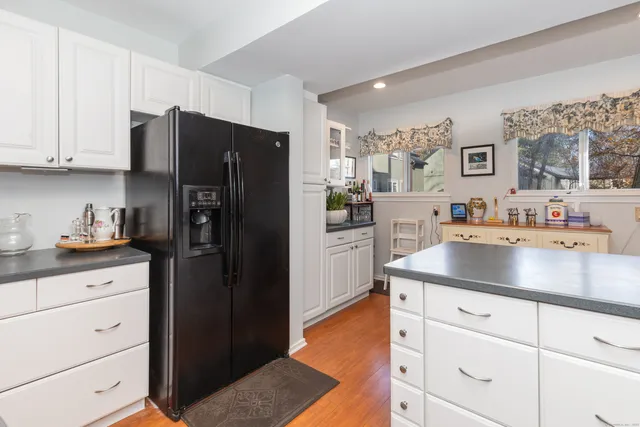 a kitchen with stainless steel appliances granite countertop a refrigerator and a sink