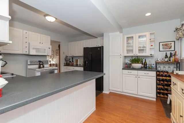 a kitchen with stainless steel appliances granite countertop a refrigerator and a stove top oven