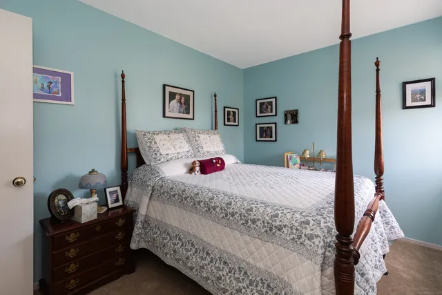 a bedroom with a bed and hallway