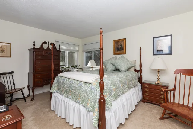 a bedroom with a bed and a mirror