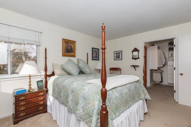 a bed room with a bed and a window