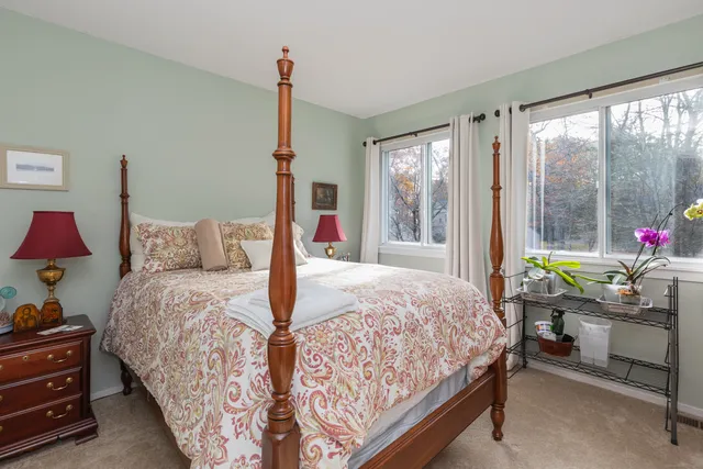 a bedroom with double bed and a window