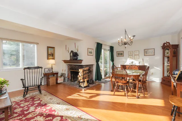 a dining room with furniture a rug and wooden floor