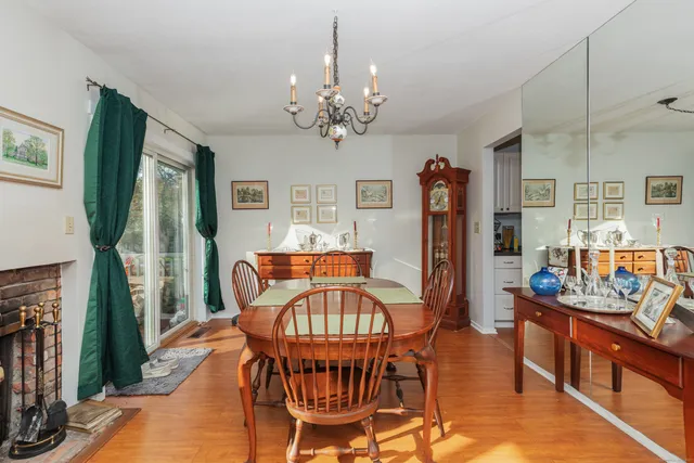 a view of a dining room with furniture a chandelier and wooden floor