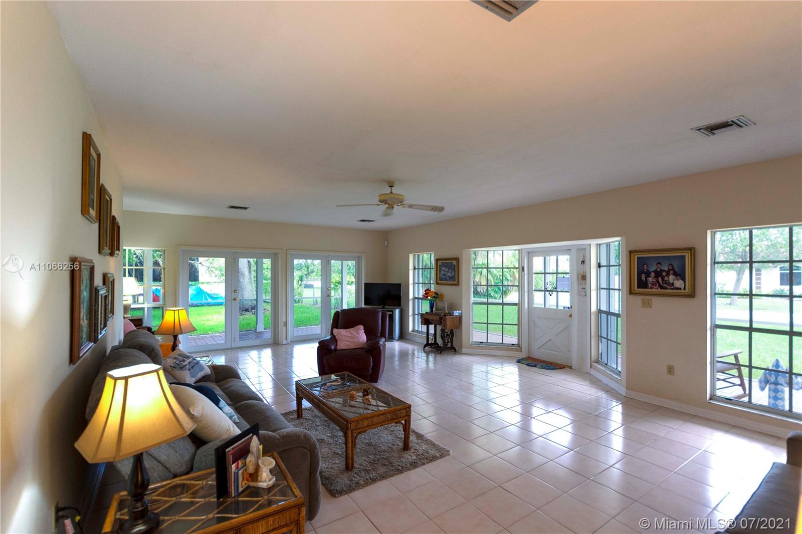 16721 Southwest 278th Street Homestead, FL 33031 - Photo 2 of 20 a living room with furniture and a flat screen tv