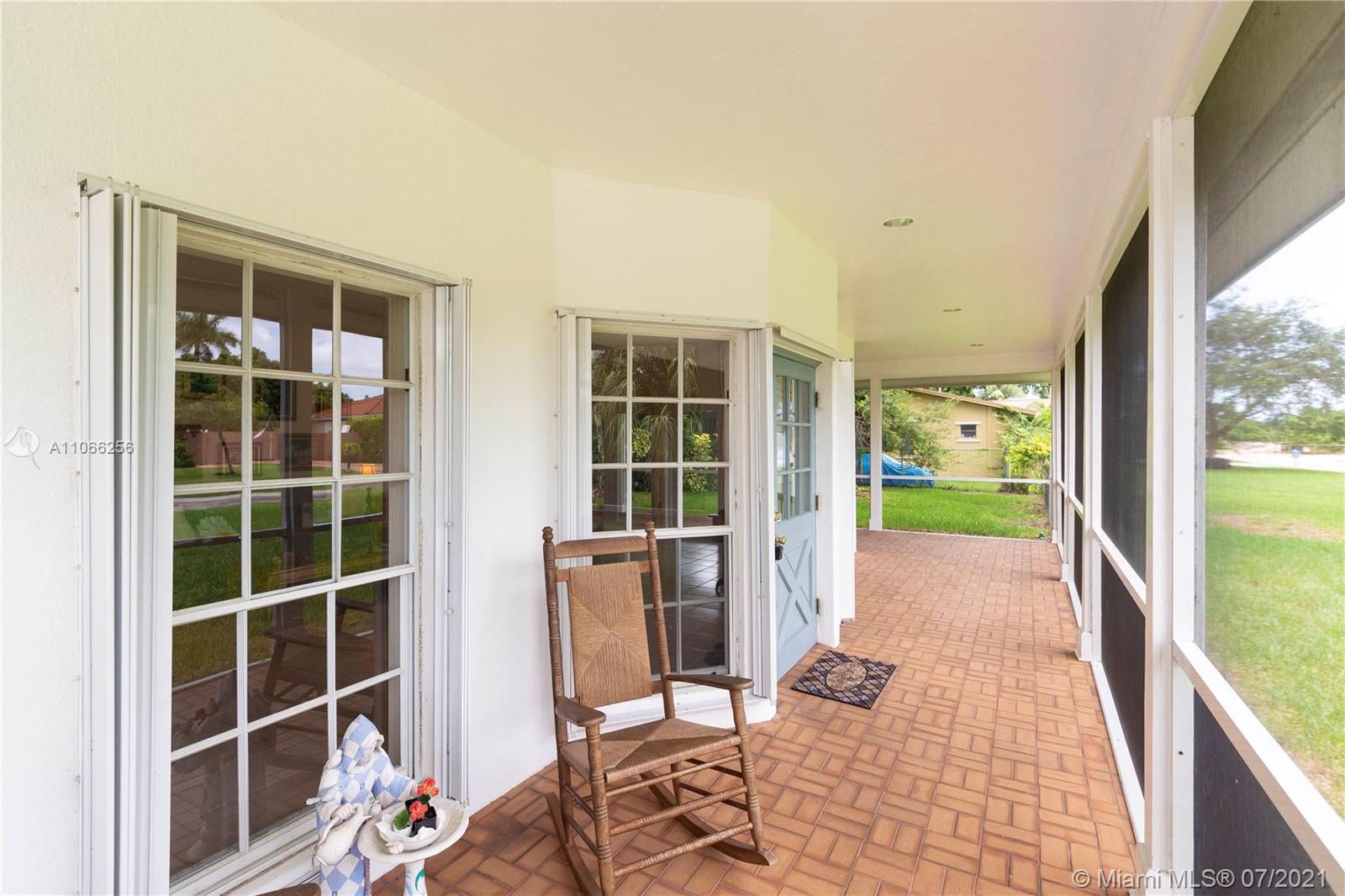 16721 Southwest 278th Street Homestead, FL 33031 - Photo 13 of 20 a view of a porch with wooden floor and a potted plant