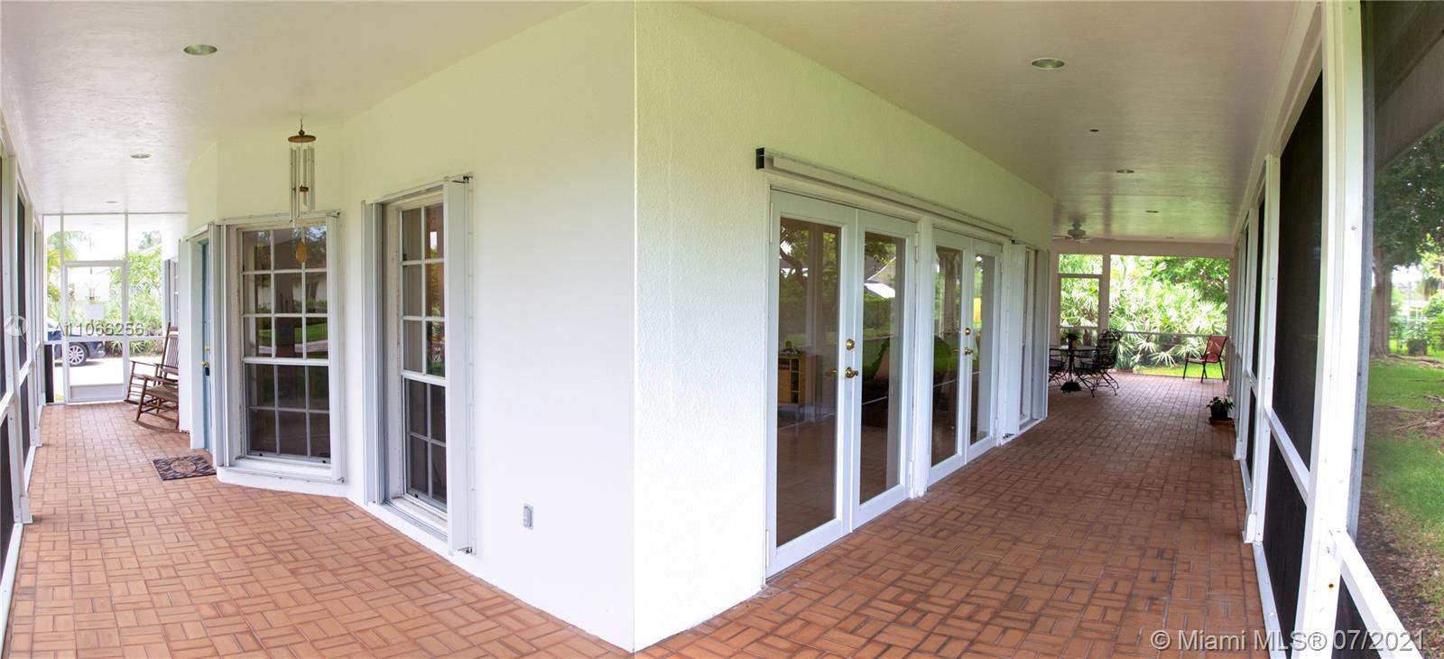 16721 Southwest 278th Street Homestead, FL 33031 - Photo 14 of 20 a view of a hallway with wooden shelves