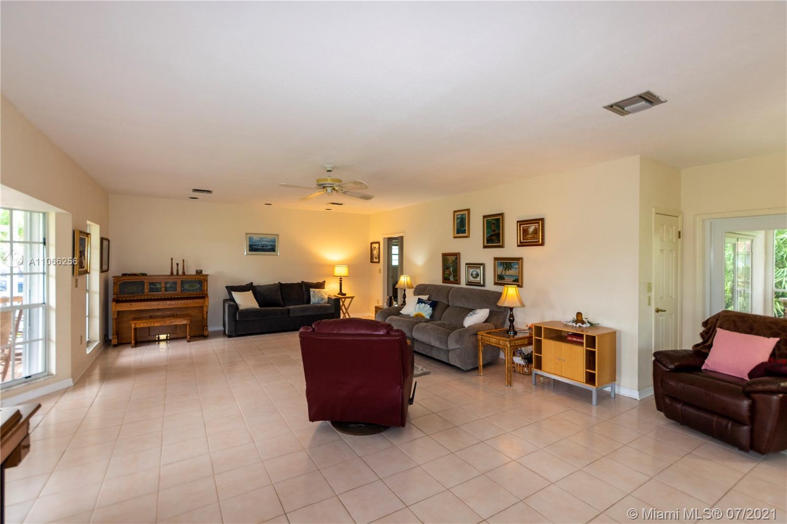 16721 Southwest 278th Street Homestead, FL 33031 - Photo 9 of 20 a living room with furniture and a flat screen tv