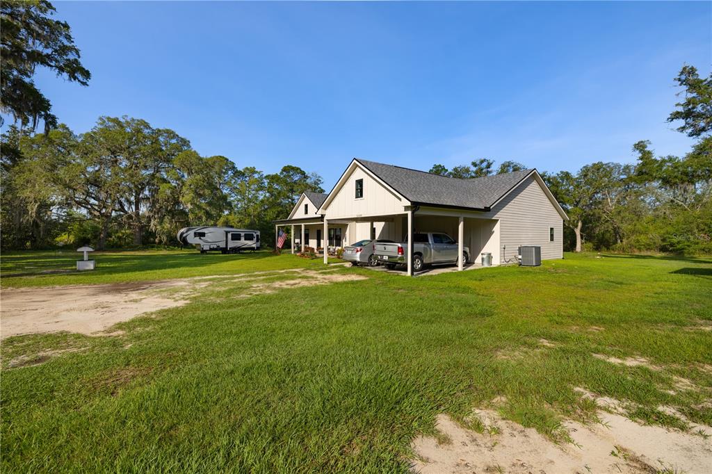 5149 Southwest 119th Road Lake Butler, FL 32054 - Photo 10 of 40 a front view of a house with garden