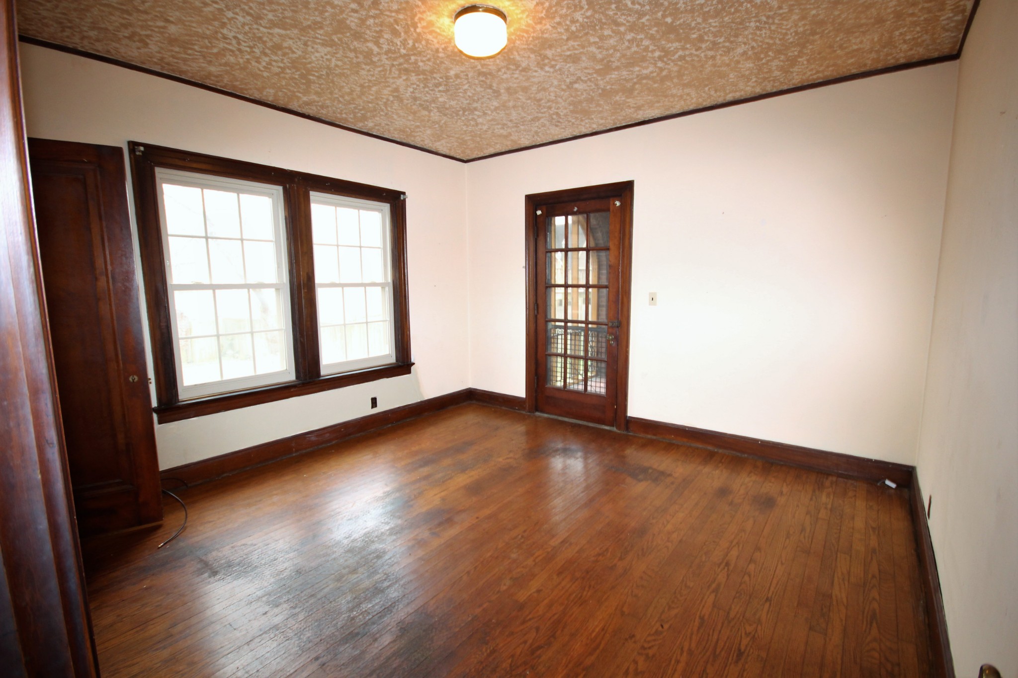 310 North Garner Street Springfield, TN 37172 - Photo 13 of 22 an empty room with wooden floor and windows