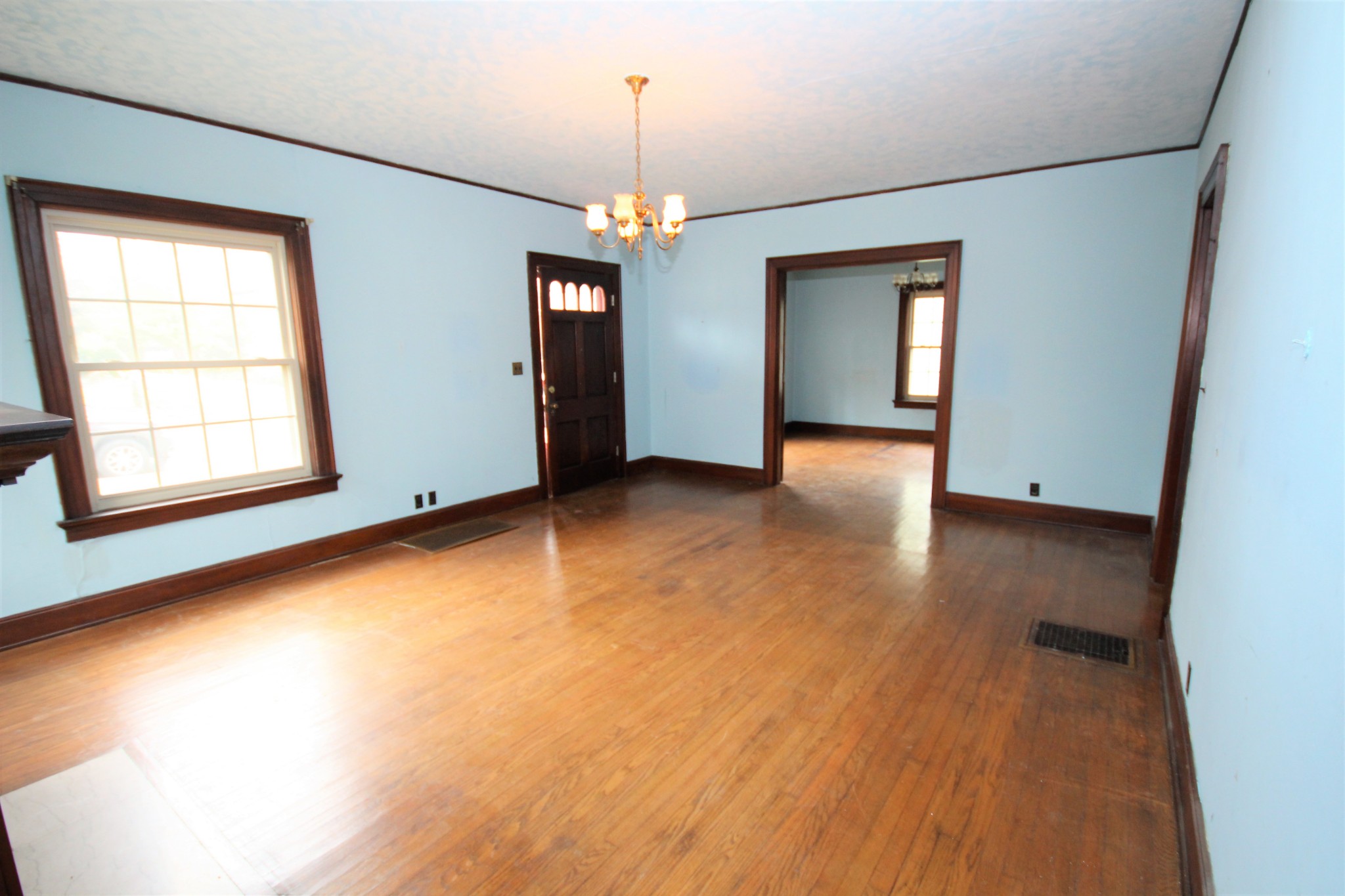 310 North Garner Street Springfield, TN 37172 - Photo 8 of 22 an empty room with wooden floor chandelier and windows